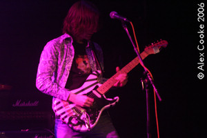 Photo of Mark playing on stage with Static Rain